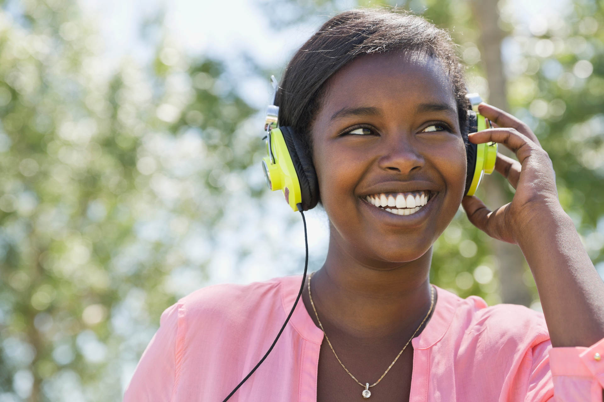 Woman wearing headphones and smiling